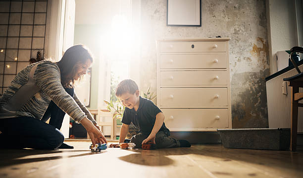 Learn together, grow together Shot of a little boy and his mother playing with toys together at home kids playing with toys stock pictures, royalty-free photos & images