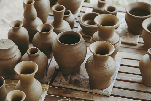 Leather hard handcraft clay pots waiting for dry and bisque fire in pottery process.