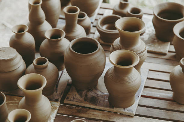 Leather hard handcraft clay pots waiting for dry and bisque fire in pottery process. stock photo
