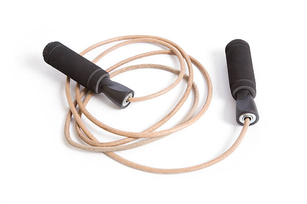 Leather Jump Rope, Exercise Equipment on White Coiled sports jump rope with black cushioned handles for fitness workouts. terryfic3d stock pictures, royalty-free photos & images