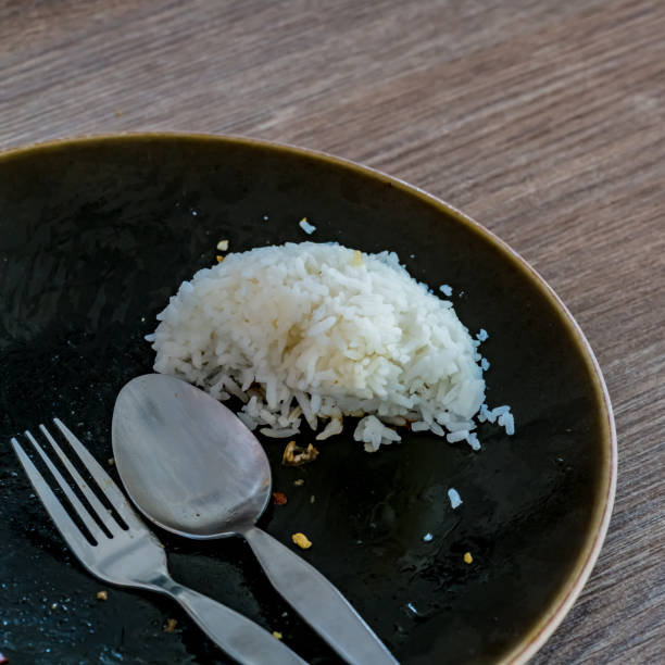 Leftover rice on dish stock photo