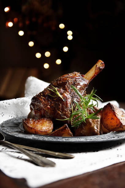 Leg Of Lamb 1 Traditionally cooked Leg of Lamb, also termed Lamb Shank, together with slow cooked roasted potatoes with rosemary and crushed garlic. Generous accommodation for copy space. rosemary photos stock pictures, royalty-free photos & images