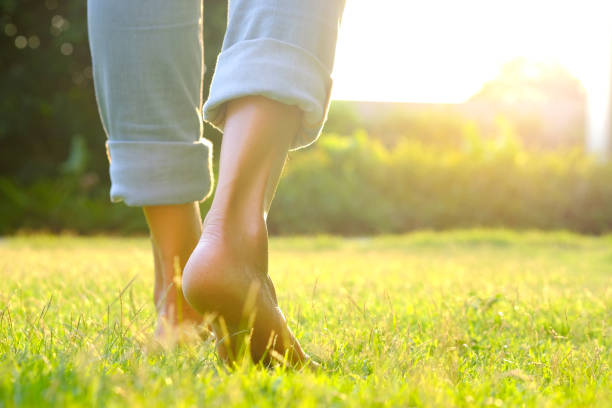 Leg of woman is on the ground. She is about to walk down the grass to exercise in the morning. Health and Relaxation Concepts Leg of woman is on the ground. She is about to walk down the grass to exercise in the morning. Health and Relaxation Concepts recovery stock pictures, royalty-free photos & images