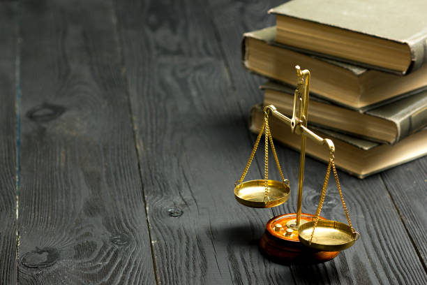 Legal Law concept - Open law book with a wooden judges gavel on table in a courtroom or law enforcement office. Copy space for text stock photo