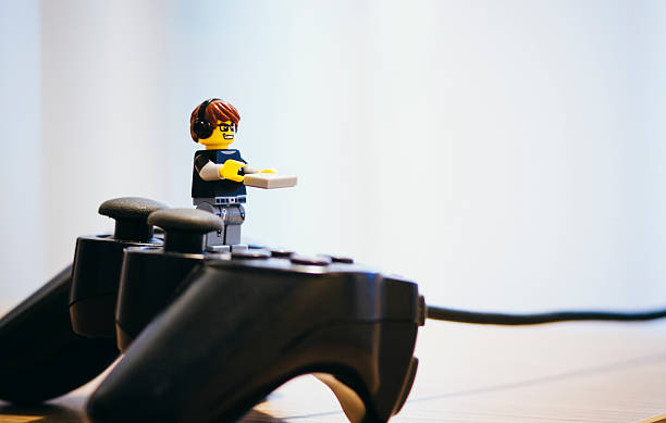 Lego man turn on the game consolle Orvieto, Italy - February 11, 2015: Lego man turn on the game consolle. Lego is a popular line of construction toys manufactured by the Lego Group xbox photos stock pictures, royalty-free photos & images