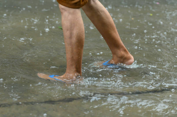 Legs walking through the flood stock photo