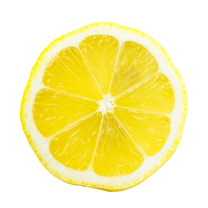 Slice of lemon isolated on white background. The perspective of the image is top view while you can see the seeds through it. It is a bright and clear image with a beautiful yellow.