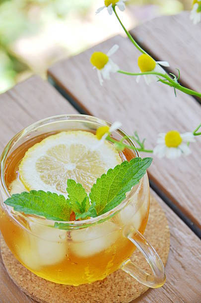 lemon tea with herbs stock photo