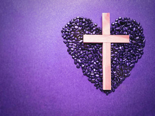Lent Season,Holy Week and Good Friday Concepts Photo of wooden cross and pebbles in purple vintage background. Stock photo. good friday stock pictures, royalty-free photos & images