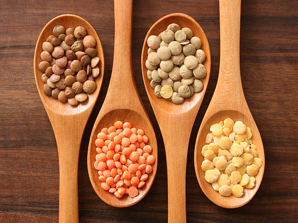 Lentils and spoons Four spoons with varieties of lentils lentil stock pictures, royalty-free photos & images