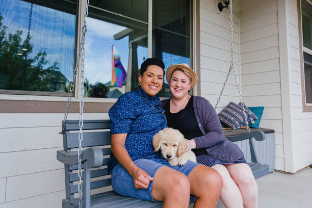 Lesbian Couple On Front Porch Swing stock photo