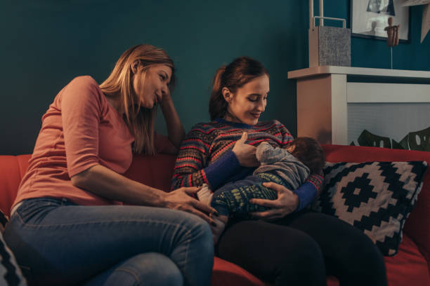 Lesbian Couple With Their Baby Son At Home stock photo