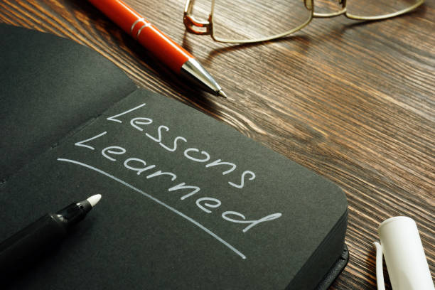 Lessons learned mark on the black page. stock photo