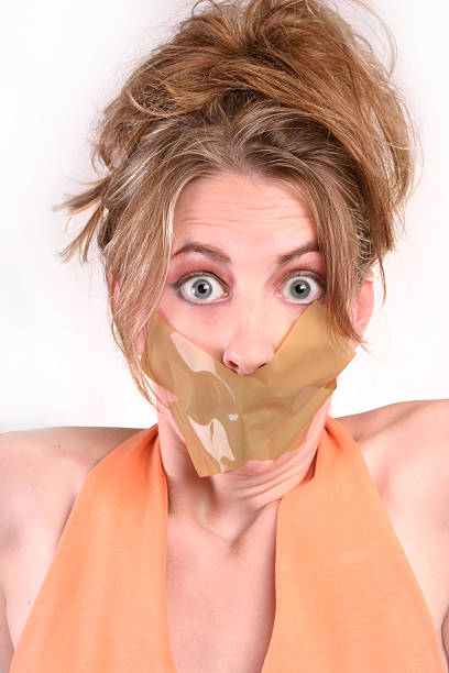Let Me Speak! A censored woman with tape over her mouth. human mouth gag adhesive tape women stock pictures, royalty-free photos & images