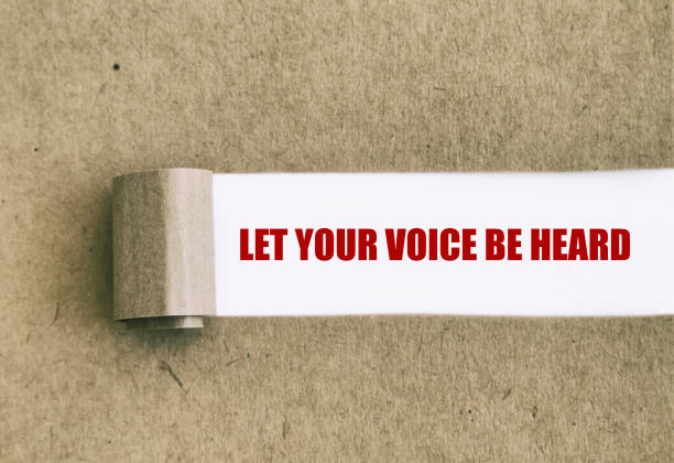 Let your voice be heard written under torn paper. stock photo