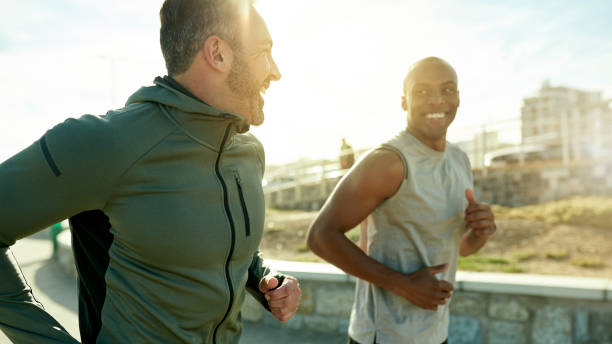 Let's get to those goals Shot of two sporty men exercising together outdoors health and wellness stock pictures, royalty-free photos & images