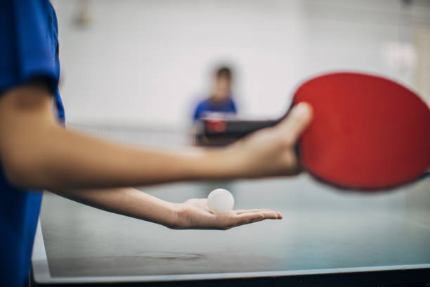 Let's play table tennis One woman, holding table tennis racket, ready to serve, part of. table tennis stock pictures, royalty-free photos & images