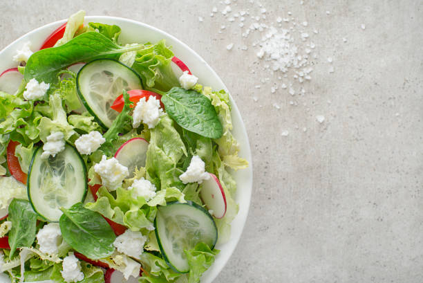 Lettuce salad with mixed vegetable and fresh cheese stock photo