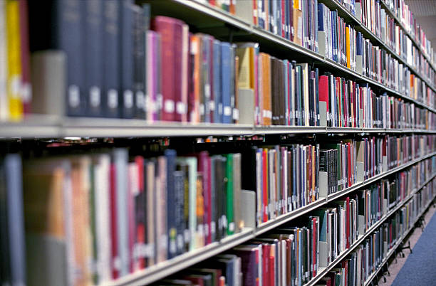 Library bookshelves filled with rows of books stock photo