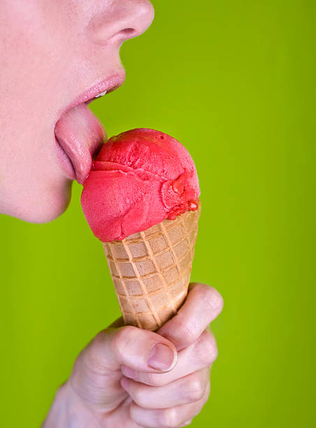 Licking a red icecream stock photo