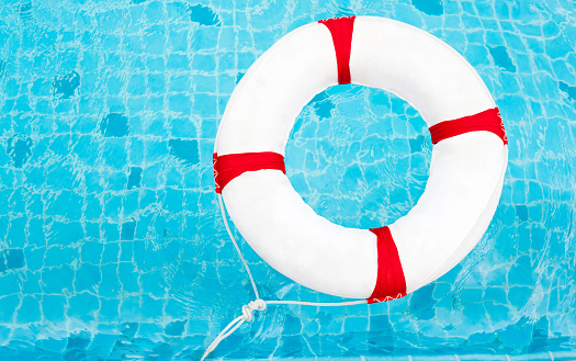 Life Ring At The Swimming Pool Life Ring On Water Stock Photo - Download Image Now - iStock