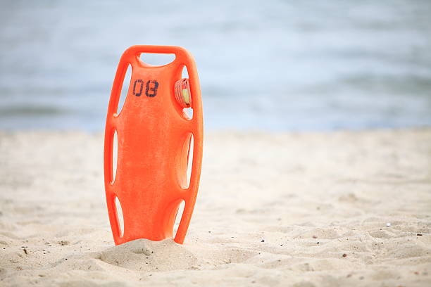 Beach life-saving. Lifeguard rescue equipment orange preserver tool,...