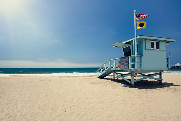 Lifeguard hut Lifeguard hut on Manhattan Beach, Los Angeles county. American and 'no surfing' flag blowing in the wind. lifeguard stock pictures, royalty-free photos & images