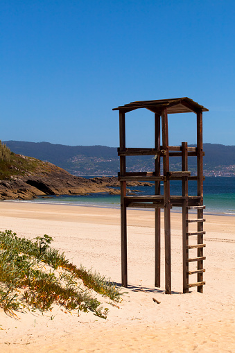 Lifeguard small watchtower silhouette, beach, seascape. Canelas beach, Sanxenxo, Pontevedra  province, Galicia, Spain