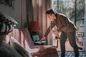 istock Lifehack asian chinese mid adult man practicing saxophone at living room online virtual class with his tutor using laptop 1307408009