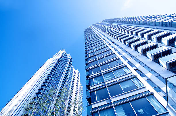 Lifestyle Residential Apartments Residential Skyscrapers with diminishing perspective, Trees and clear sky backdrop flat physical description stock pictures, royalty-free photos & images