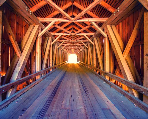 Light at the end of the tunnel, Inside wood covered bridge in Maine USA. Light at the end of the tunnel, Inside wood covered bridge in Maine USA. covered bridge stock pictures, royalty-free photos & images