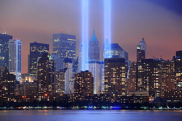 Light beams representing the Twin Towers in New York City  New York City Manhattan downtown skyline at night from Liberty Park with light beams in memory of September 11 viewed from New Jersey waterfront. september 11 2001 attacks stock pictures, royalty-free photos & images
