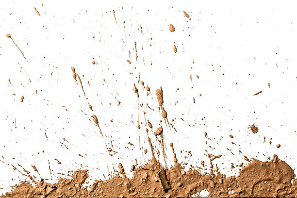 Light brown clay artistically sprayed up Effect generated by splashing mud on white background. mud stock pictures, royalty-free photos & images