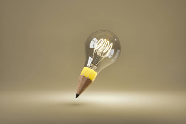 light bulb illuminated with pencil tip stock photo