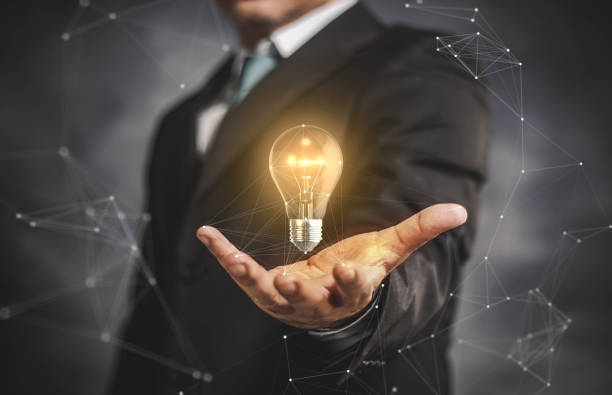 light bulb with businessman on his hand. stock photo