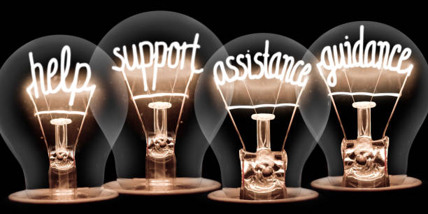 Light Bulbs Concept Photo of light bulbs group with shining fibers in a shape of HELP, SUPPORT, ASSISTANCE, GUIDANCE concept words isolated on black background support stock pictures, royalty-free photos & images