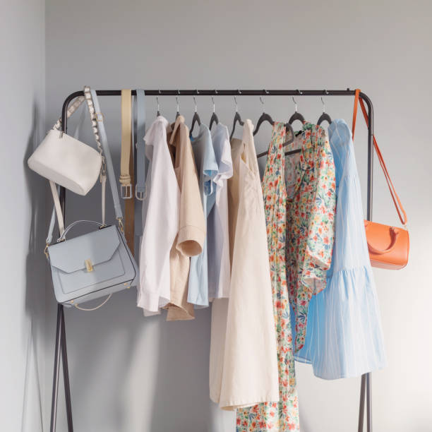light colored womens summer clothes  on  hanger - kasten stockfoto's en -beelden