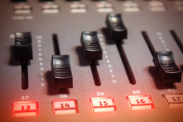 Light console fader button Close-up of light console, fader button in selective focus, with some faders up. Allows graduate more or less light on stage with dimmer console in DMX (Digital MultipleX) protocol. dmx stock pictures, royalty-free photos & images