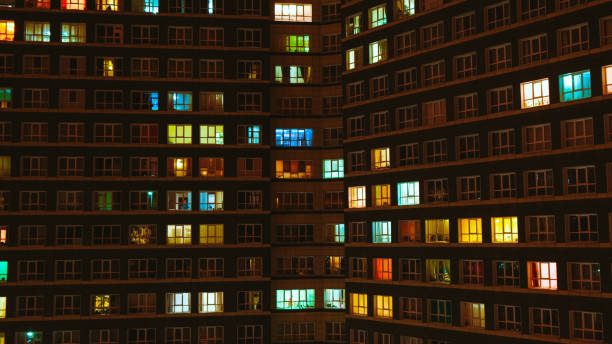 Light in the windows of a multistory building. Time lapse stock photo