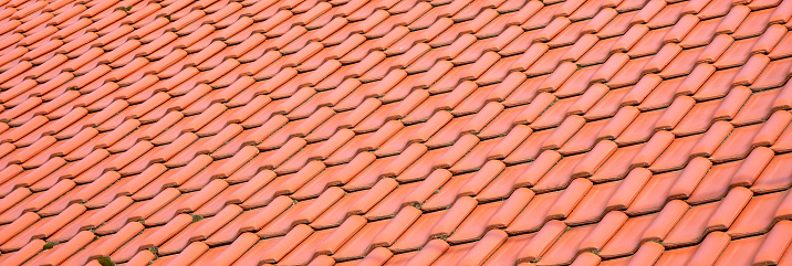 Light orange classic roof tiles, new roof covering, traditional roofing service concept. Simple wide clean banner, roof surface material abstract background texture, backdrop, object closeup, nobody