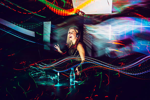 DJ, Light Painting Female DJ in a nightclub, enjoying, happy, light painting, colors, DJ Calixta, Motion Trails techno music stock pictures, royalty-free photos & images