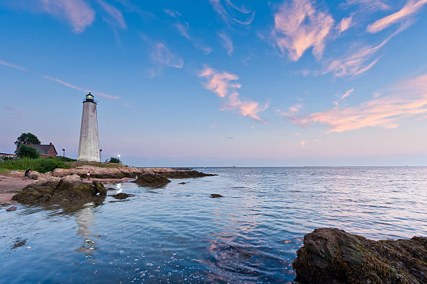 Lighthouse at Dusk Sunset at the beach in Lighthouse point Park, New haven, Connecticut connecticut stock pictures, royalty-free photos & images