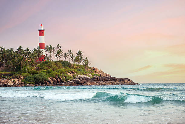 Lighthouse on the cliff in Kovalam Beach stock photo