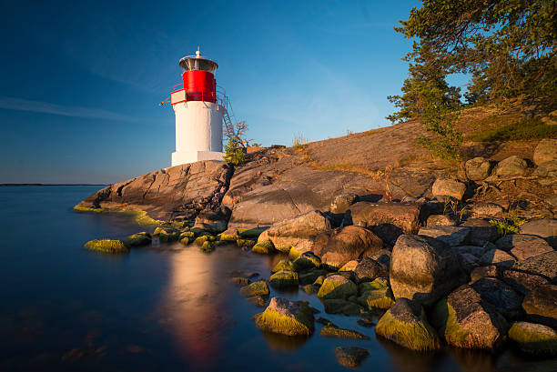 Lighthouse on the Swedish archipelago island at sunset stock photo