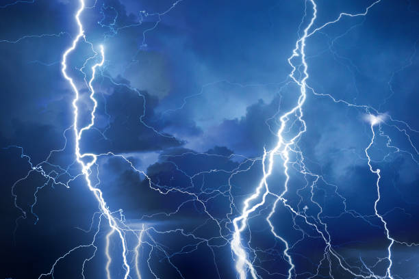 Lightning during storm at night stock photo