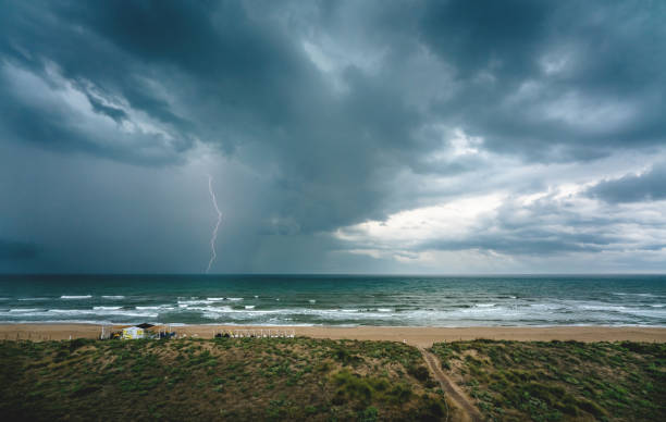 Lightning flash and thunderstorm over the ocean along the Mediterranean coast in Daimus, Spain stock photo