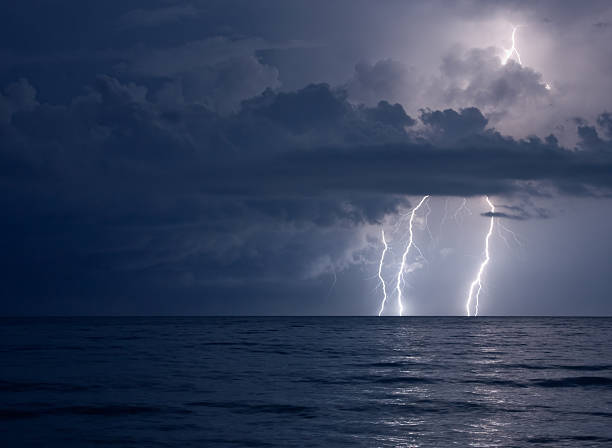 lightning over water stock photo