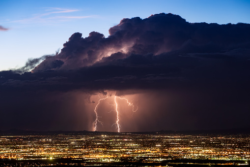 Lightning bolt strikes from a monsoon thunderstorm over Phoenix, Arizona.