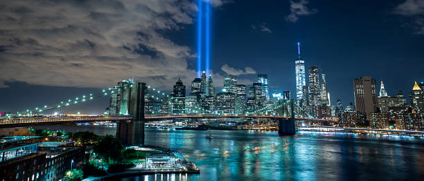9/11 Lights and the Brooklyn Bridge - Masterpiece A breathtaking view of the 9/11 Lights and Brooklyn Bridge. 911 new york stock pictures, royalty-free photos & images
