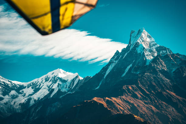 Lightweight aircraft above valley Himalayn mountain near Machapuchare Mardi Himal track in the Himalaya mountains stock photo
